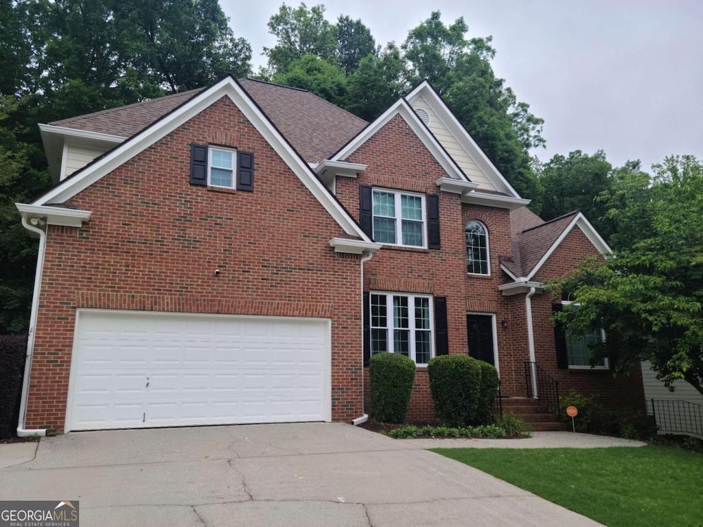 1558 Ember Oaks Cir, Powder Springs, GA 30127 - traditional-style house with concrete driveway, brick siding, and a garage