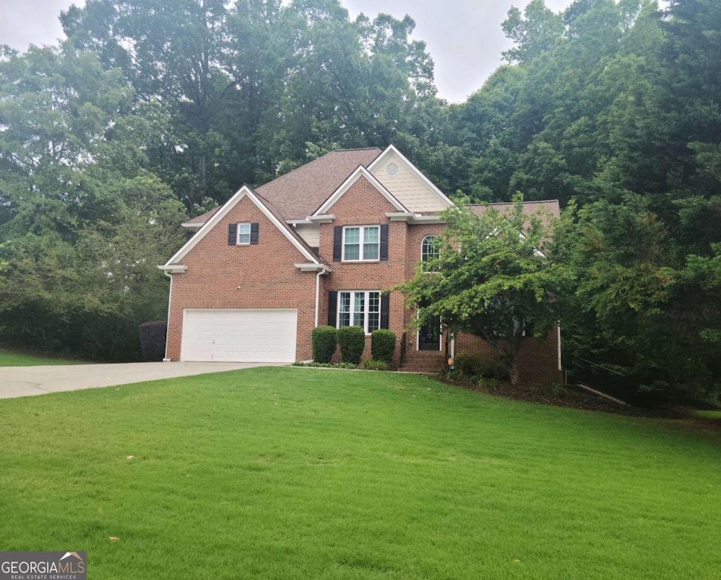 1558 Ember Oaks Cir, Powder Springs, GA 30127 - view of front of home featuring an attached garage, driveway, brick siding, and a front yard