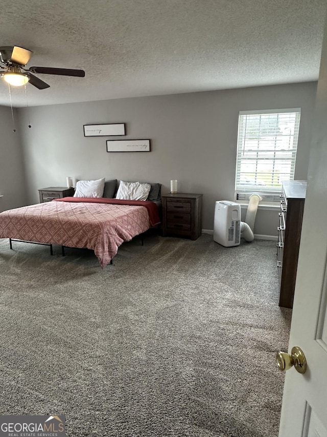 carpeted bedroom featuring a textured ceiling and ceiling fan
