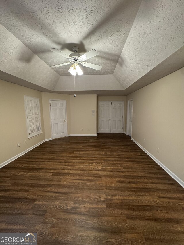 143 Tracy Ln, Mcdonough, GA 30253 - unfurnished bedroom featuring lofted ceiling, baseboards, wood finished floors, a textured ceiling, and ceiling fan