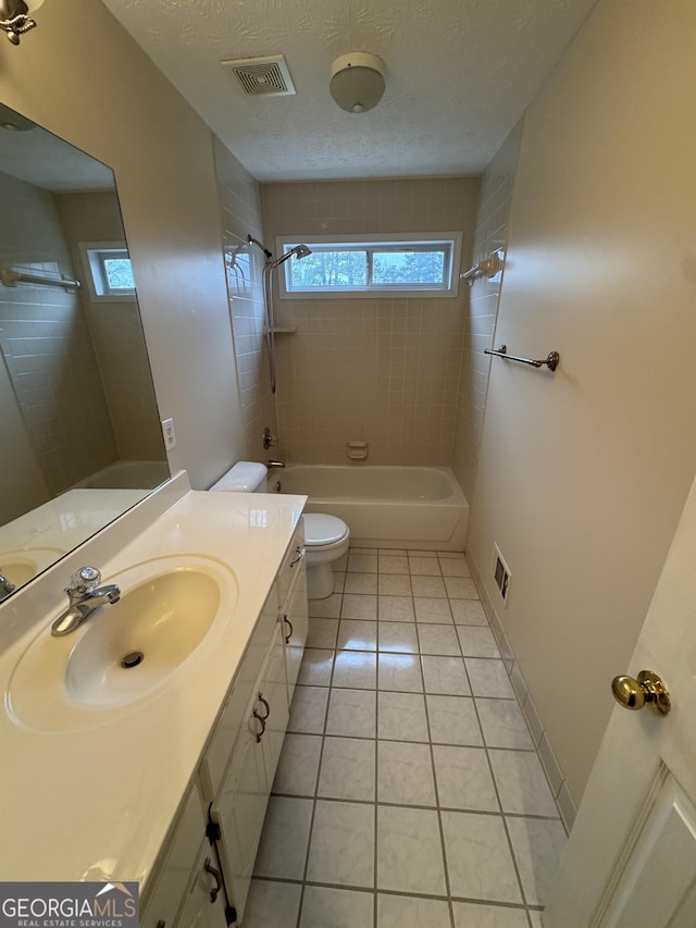 143 Tracy Ln, Mcdonough, GA 30253 - full bath with healthy amount of natural light, toilet, washtub / shower combination, and tile patterned flooring
