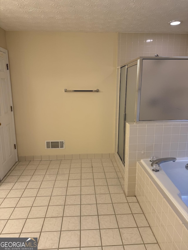 143 Tracy Ln, Mcdonough, GA 30253 - full bathroom with a bath, a stall shower, and a textured ceiling