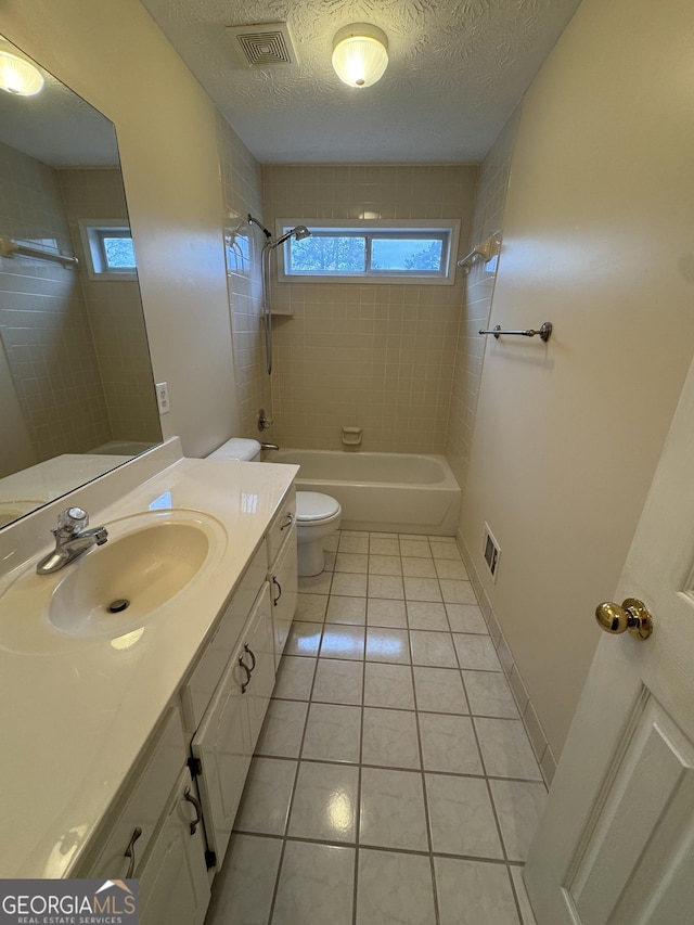 143 Tracy Ln, Mcdonough, GA 30253 - bathroom featuring toilet, tile patterned flooring, tub / shower combination, vanity, and a textured ceiling