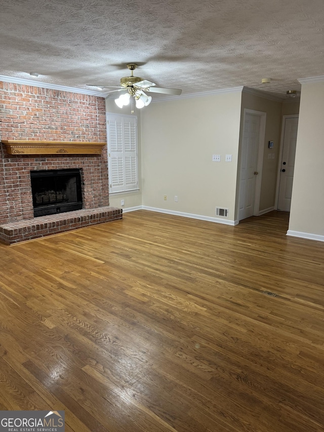 143 Tracy Ln, Mcdonough, GA 30253 - unfurnished living room with a textured ceiling, wood finished floors, baseboards, crown molding, and ceiling fan