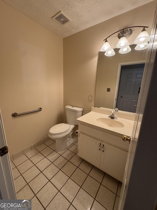 143 Tracy Ln, Mcdonough, GA 30253 - half bathroom featuring tile patterned floors, vanity, toilet, and a textured ceiling