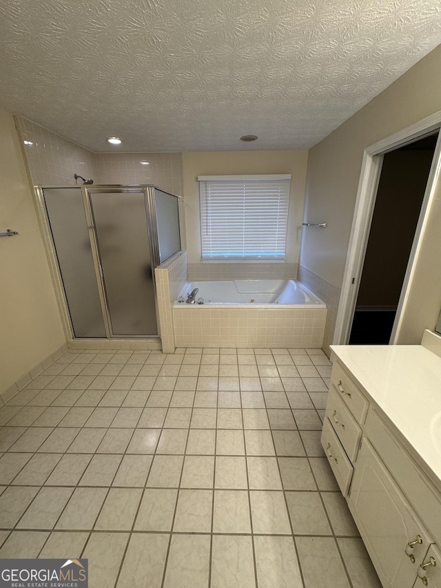 143 Tracy Ln, Mcdonough, GA 30253 - bathroom featuring a textured ceiling, a stall shower, a bath, vanity, and tile patterned flooring