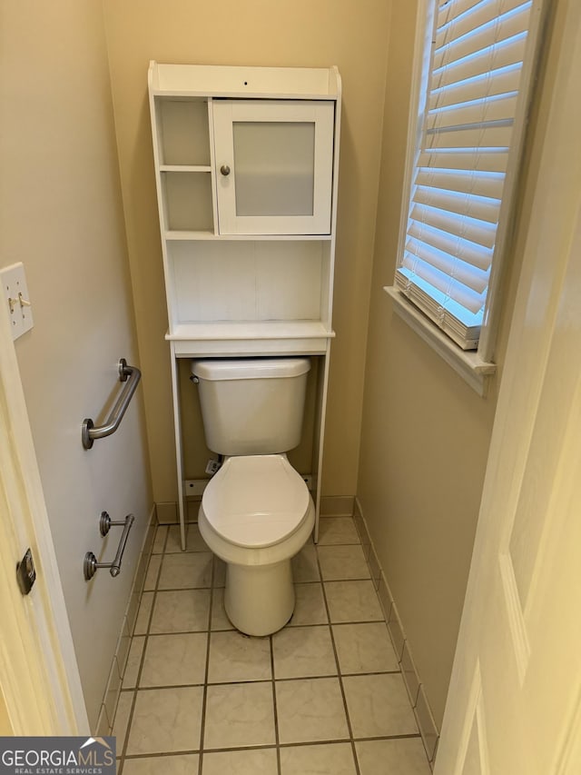 143 Tracy Ln, Mcdonough, GA 30253 - bathroom featuring toilet, baseboards, and tile patterned floors