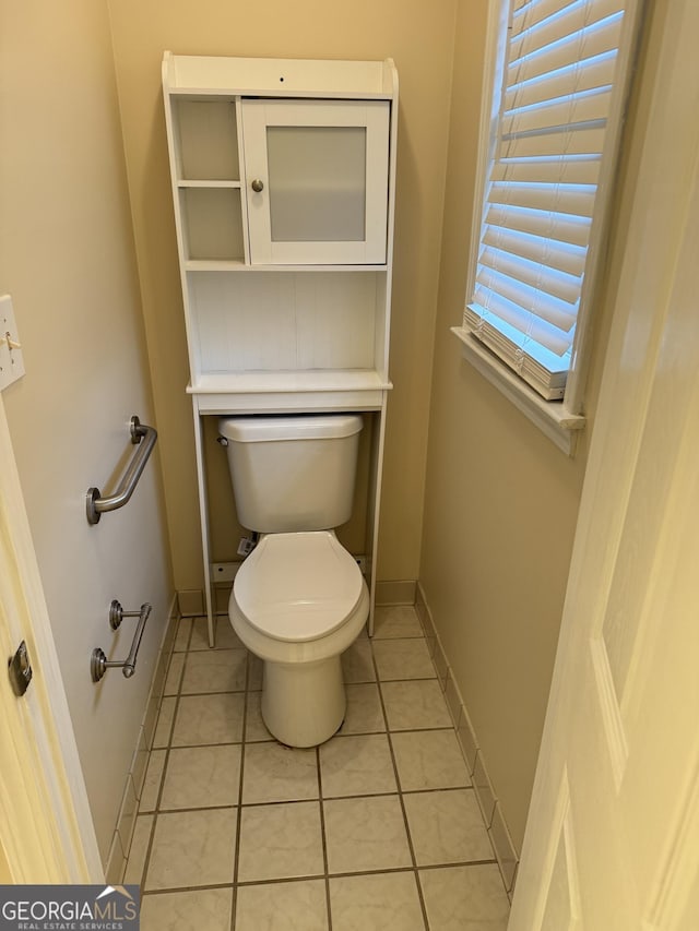 143 Tracy Ln, Mcdonough, GA 30253 - bathroom with toilet, tile patterned floors, and baseboards