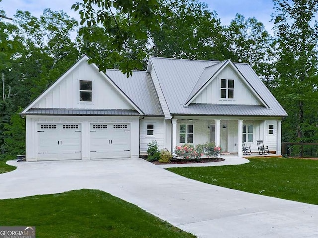 2700 Sam Nelson Rd, Canton, GA 30114 - modern farmhouse style home featuring board and batten siding, concrete driveway, a porch, a front yard, and metal roof