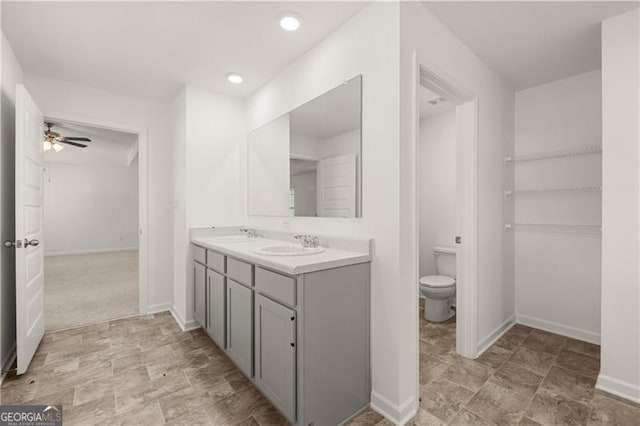 45 Vermillion Way, Covington, GA 30016 - bathroom featuring double vanity, a ceiling fan, and stone finish floors
