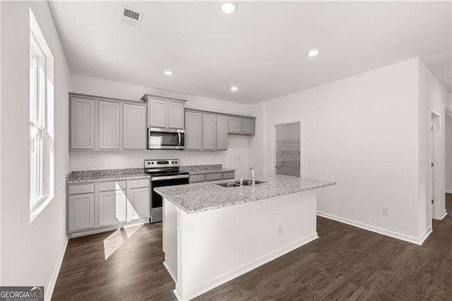 45 Vermillion Way, Covington, GA 30016 - kitchen featuring appliances with stainless steel finishes, gray cabinets, a kitchen island with sink, dark wood-style floors, and recessed lighting