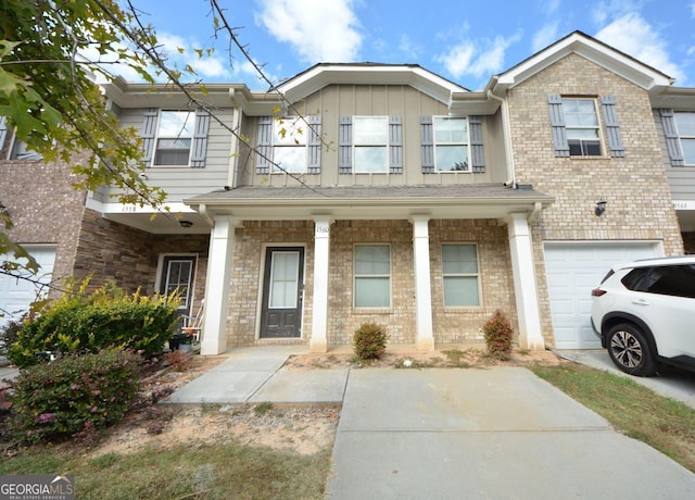1560 Iris Walk, Jonesboro, GA 30238 - multi unit property with an attached garage, board and batten siding, a porch, and brick siding