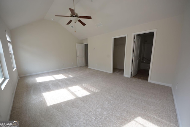 1560 Iris Walk, Jonesboro, GA 30238 - unfurnished bedroom with light carpet, vaulted ceiling, multiple windows, and baseboards