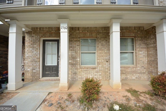 1560 Iris Walk, Jonesboro, GA 30238 - doorway to property featuring covered porch and brick siding