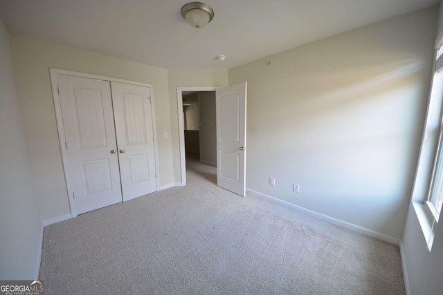 1560 Iris Walk, Jonesboro, GA 30238 - unfurnished bedroom featuring carpet floors, a closet, and baseboards