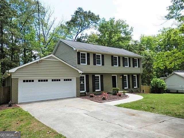1315 Arden Dr SW, Marietta, GA 30008 - colonial house featuring driveway, brick siding, and an attached garage