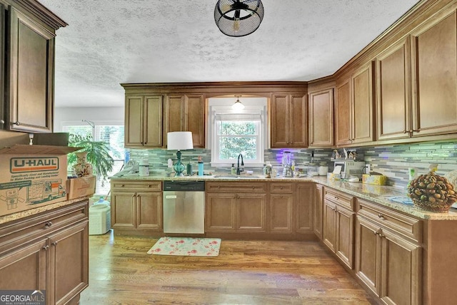 1315 Arden Dr SW, Marietta, GA 30008 - kitchen with stainless steel dishwasher, a sink, healthy amount of natural light, tasteful backsplash, and a textured ceiling