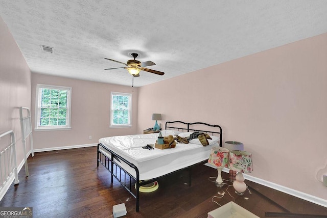 1315 Arden Dr SW, Marietta, GA 30008 - bedroom featuring wood finished floors, baseboards, a textured ceiling, and a ceiling fan