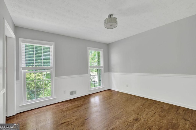 1315 Arden Dr SW, Marietta, GA 30008 - spare room featuring a textured ceiling, wood finished floors, and baseboards