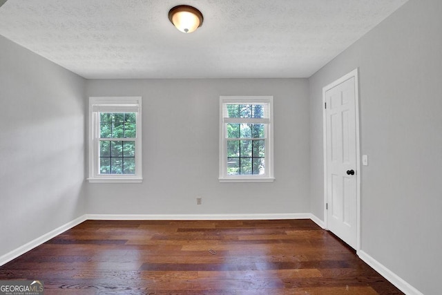 1315 Arden Dr SW, Marietta, GA 30008 - empty room featuring plenty of natural light, dark wood-style floors, a textured ceiling, and baseboards