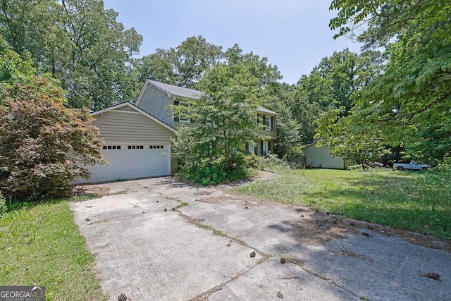 1315 Arden Dr SW, Marietta, GA 30008 - obstructed view of property featuring concrete driveway, a front yard, and a garage