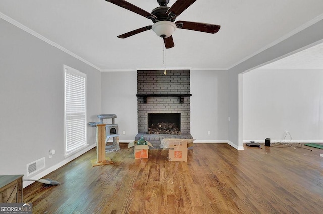 1315 Arden Dr SW, Marietta, GA 30008 - living area featuring wood finished floors, crown molding, baseboards, a brick fireplace, and a ceiling fan
