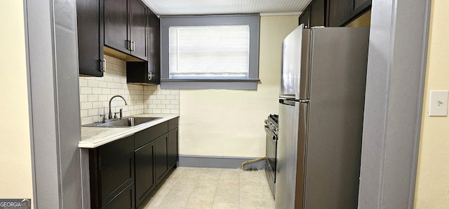 800 Verner St NW, Atlanta, GA 30318 - kitchen featuring freestanding refrigerator, a sink, light countertops, decorative backsplash, and baseboards