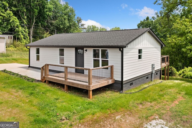 153 Church St, Ball Ground, GA 30107 - back of house featuring a shingled roof, a wooden deck, a yard, and board and batten siding