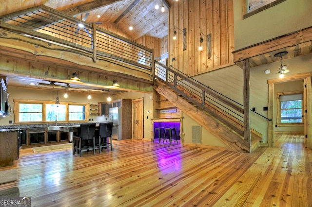 179 Huckleberry Ln, Ellijay, GA 30536 - living area featuring high vaulted ceiling, light wood-style flooring, stairway, and beamed ceiling