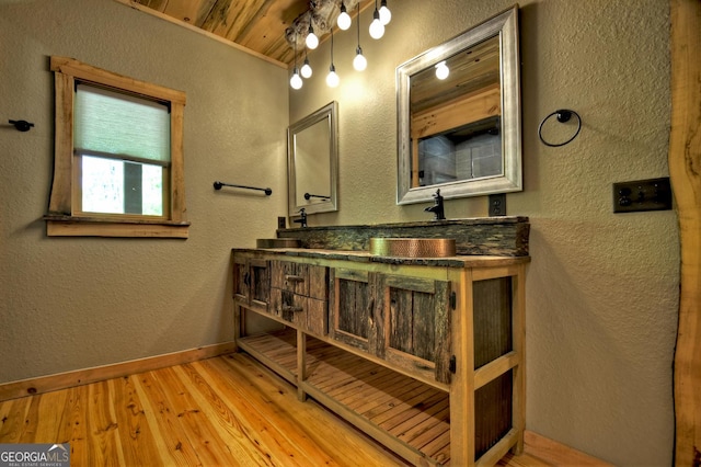 179 Huckleberry Ln, Ellijay, GA 30536 - bathroom with a textured wall, wood-type flooring, baseboards, double vanity, and wooden ceiling