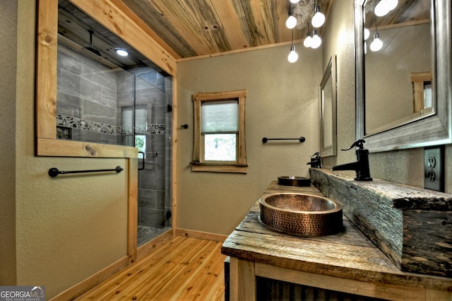 179 Huckleberry Ln, Ellijay, GA 30536 - full bathroom featuring wood finished floors, a stall shower, baseboards, double vanity, and a textured wall