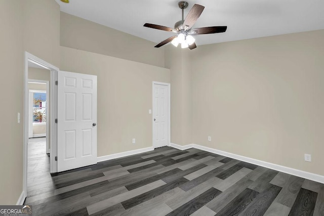 3571 Kennesaw Station Dr NW, Kennesaw, GA 30144 - unfurnished bedroom featuring dark wood-style flooring, baseboards, and a ceiling fan