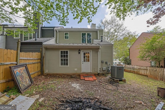 3571 Kennesaw Station Dr NW, Kennesaw, GA 30144 - rear view of property with central AC, a chimney, and a fenced backyard