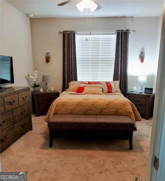 116 Four Seasons Blvd, Dallas, GA 30132 - bedroom with light carpet and ceiling fan