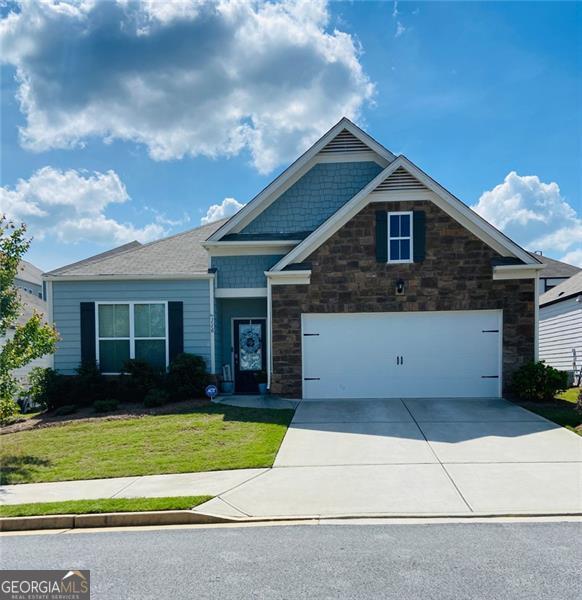 116 Four Seasons Blvd, Dallas, GA 30132 - craftsman house with driveway, a front yard, stone siding, and a garage