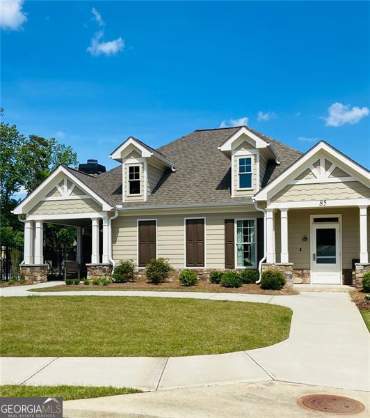 116 Four Seasons Blvd, Dallas, GA 30132 - craftsman-style home with a front lawn, stone siding, a shingled roof, and covered porch