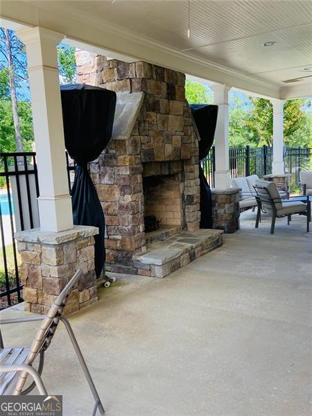 116 Four Seasons Blvd, Dallas, GA 30132 - view of patio / terrace featuring an outdoor stone fireplace and fence