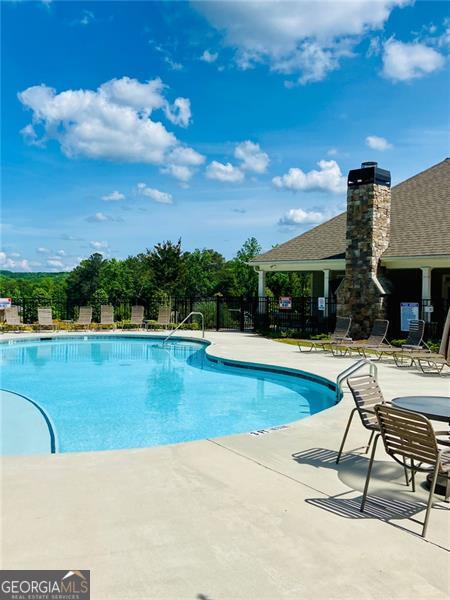 116 Four Seasons Blvd, Dallas, GA 30132 - community pool with fence and a patio area