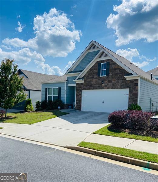 116 Four Seasons Blvd, Dallas, GA 30132 - craftsman-style house featuring driveway, a garage, and stone siding