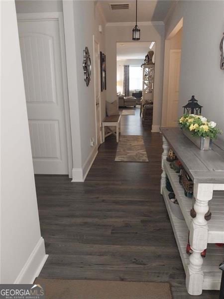 116 Four Seasons Blvd, Dallas, GA 30132 - hall with crown molding, baseboards, and dark wood-type flooring