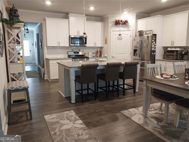 116 Four Seasons Blvd, Dallas, GA 30132 - kitchen with appliances with stainless steel finishes, ornamental molding, recessed lighting, white cabinetry, and decorative backsplash