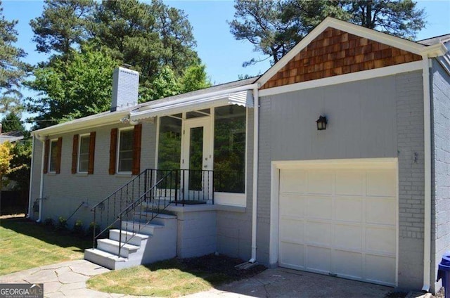 2381 Eastway Rd, Decatur, GA 30033 - single story home featuring brick siding, a chimney, and a garage
