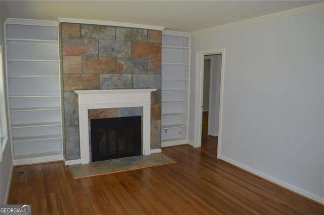 2381 Eastway Rd, Decatur, GA 30033 - unfurnished living room featuring wood finished floors, a fireplace, baseboards, built in shelves, and crown molding