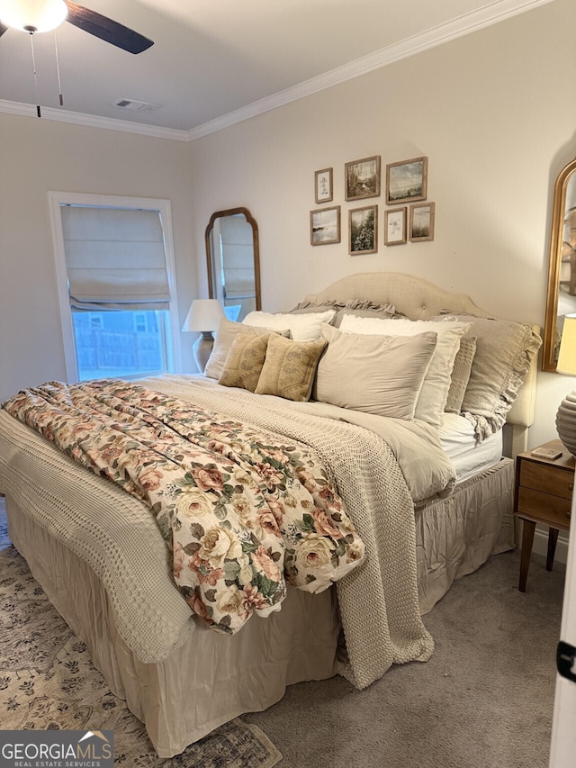 bedroom featuring crown molding, carpet flooring, and ceiling fan