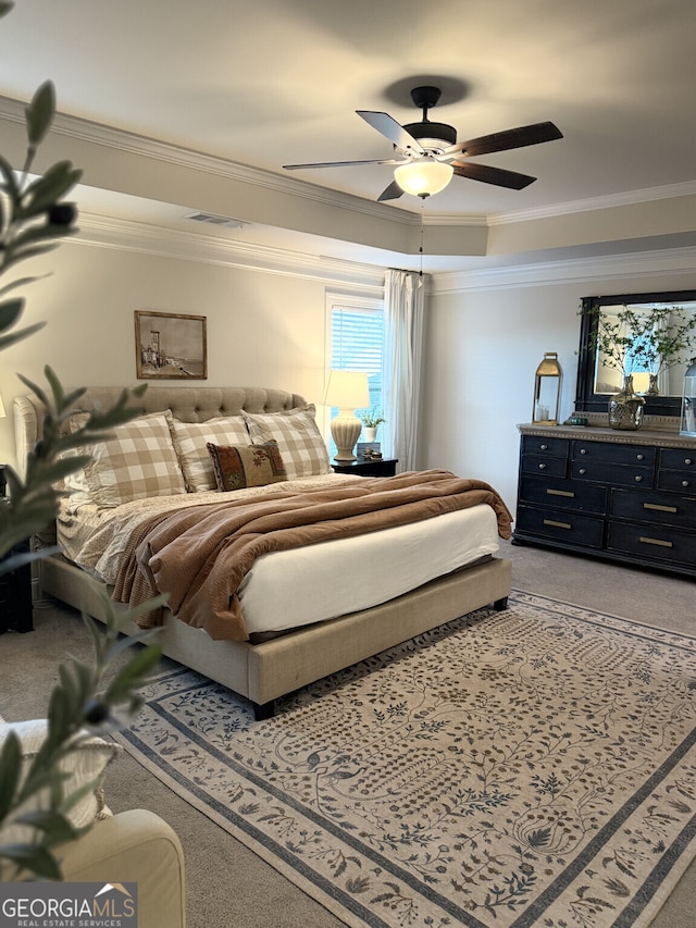 carpeted bedroom with ornamental molding and ceiling fan