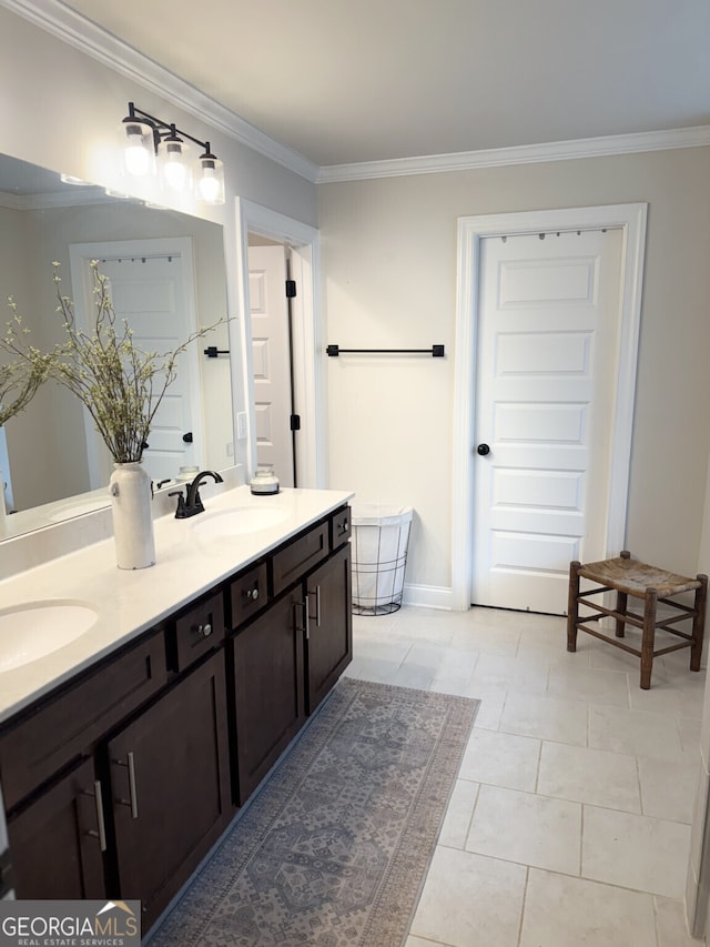 bathroom featuring crown molding and double vanity