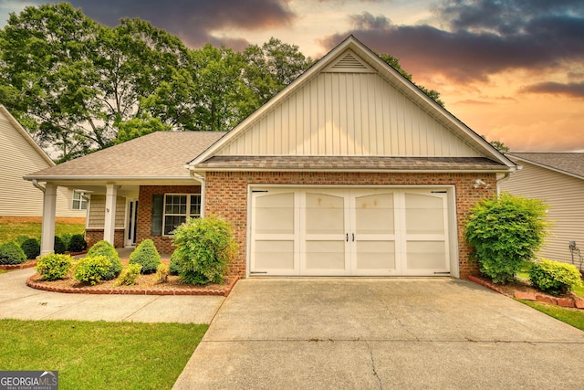 view of front of home with brick siding, concrete driveway, and board and batten siding