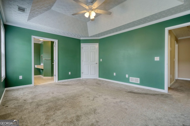unfurnished bedroom featuring a textured ceiling, carpet floors, baseboards, connected bathroom, and ceiling fan