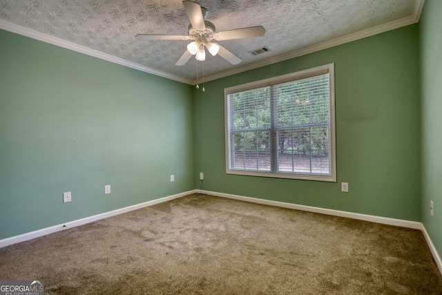 carpeted empty room featuring a ceiling fan, baseboards, and crown molding