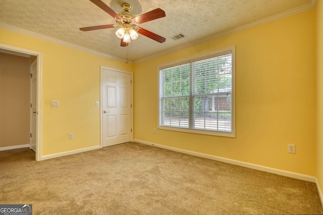 unfurnished bedroom with carpet flooring, baseboards, ornamental molding, and ceiling fan